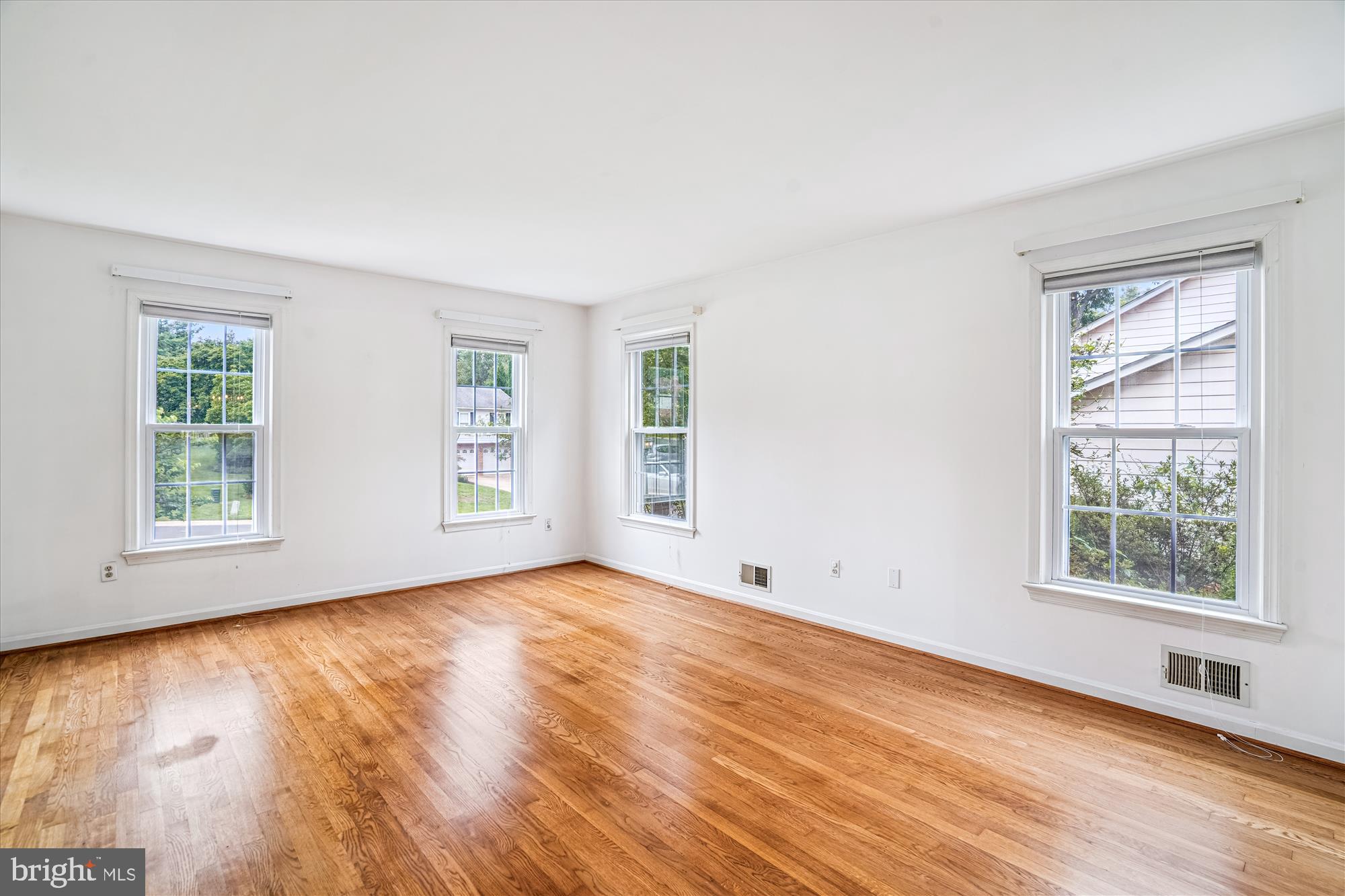 1913 Hopefield Road Silver Spring, MD 20905 - Photo 8 of 58 a view of an empty room with wooden floor and a window