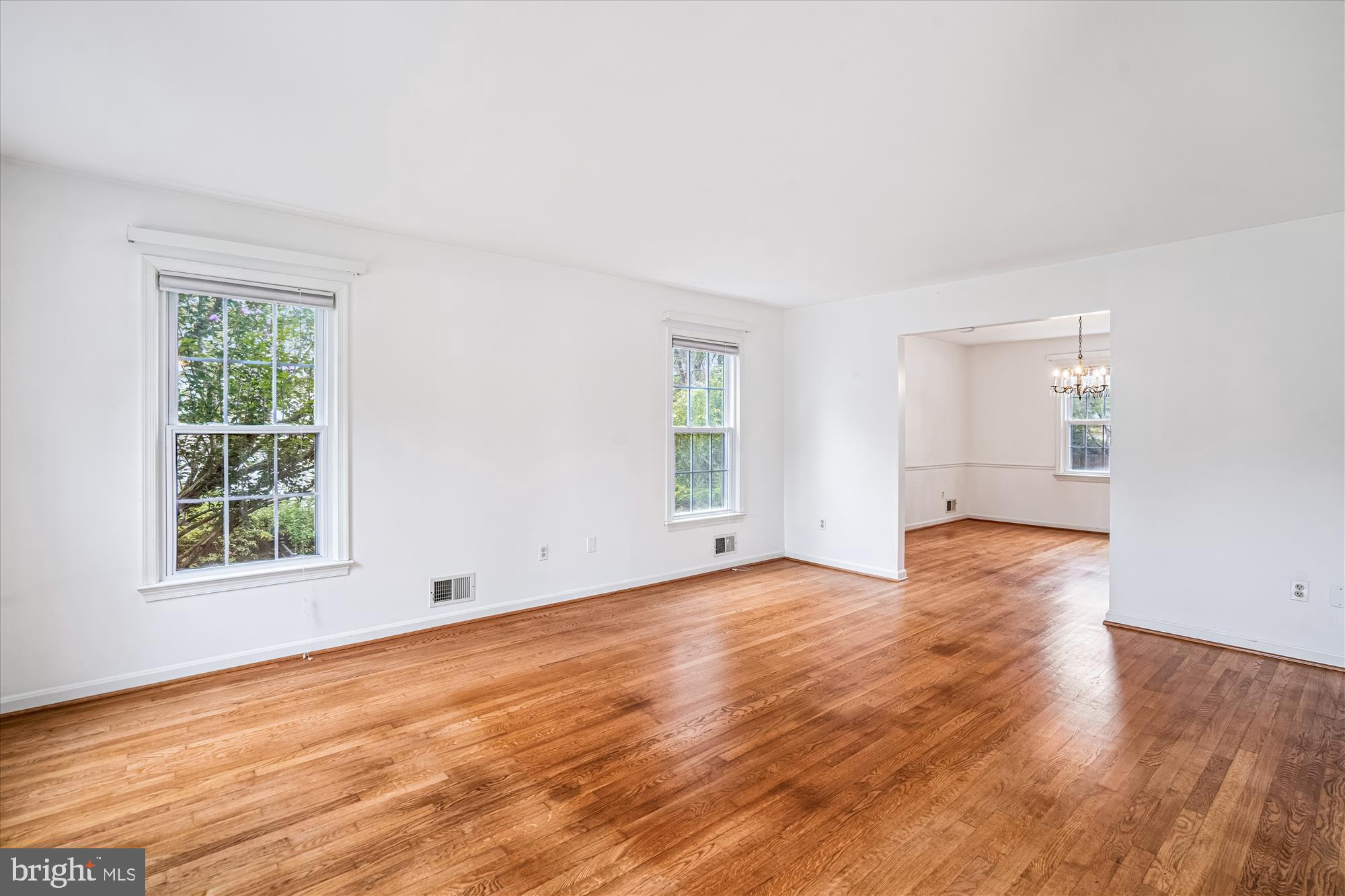 1913 Hopefield Road Silver Spring, MD 20905 - Photo 9 of 58 an empty room with wooden floor and windows