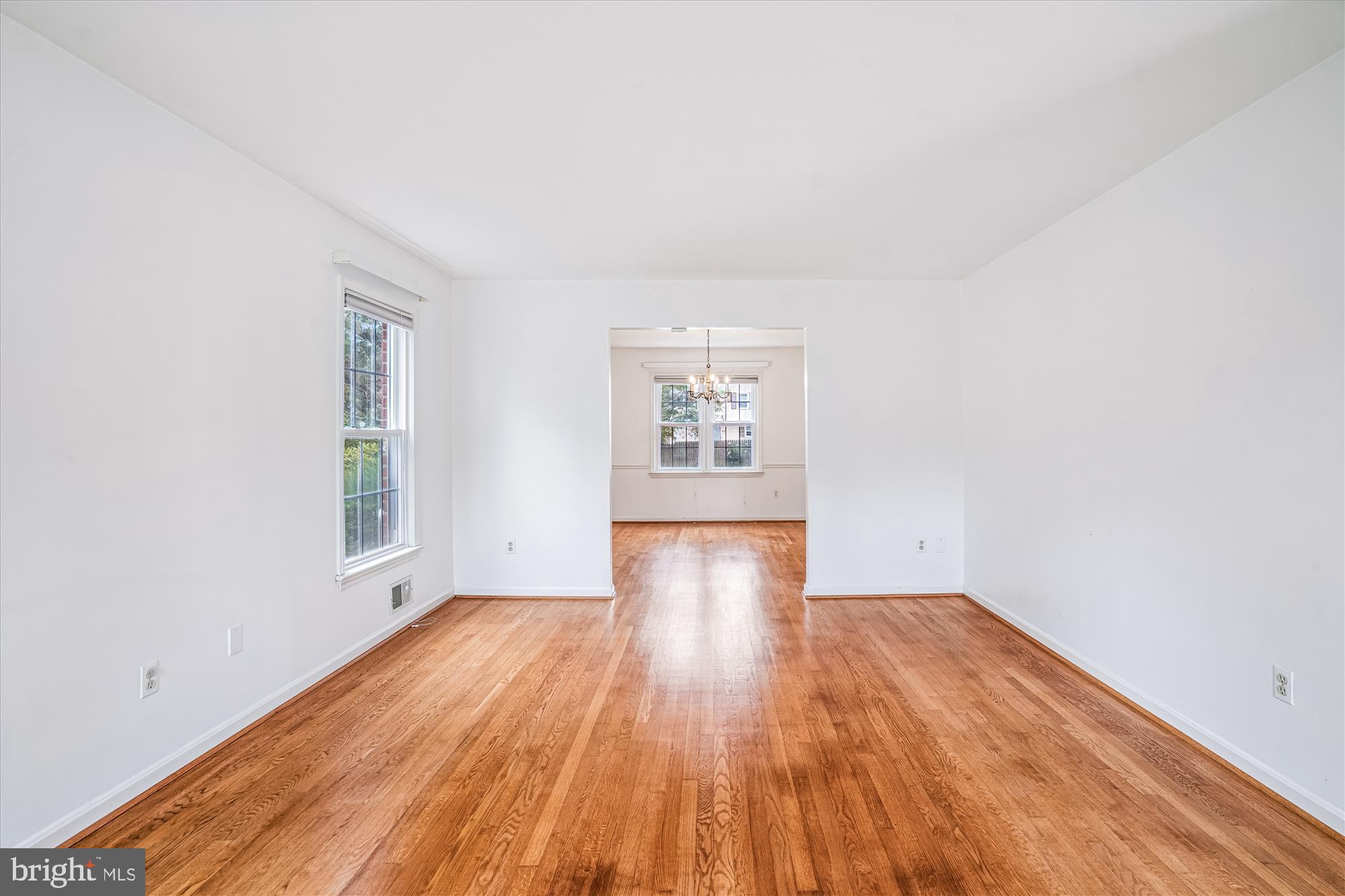 1913 Hopefield Road Silver Spring, MD 20905 - Photo 10 of 58 an empty room with wooden floor and windows