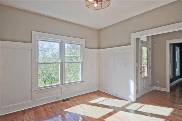 a view of a kitchen with a sink dishwasher a refrigerator and wooden floor