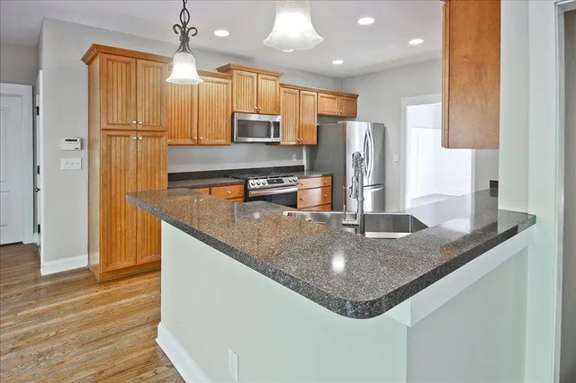 a view of a kitchen with a stove cabinets and wooden floor
