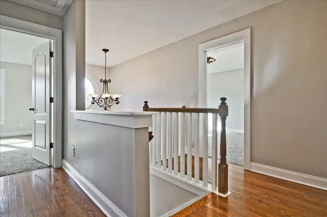 a bathroom with a granite countertop sink a toilet a mirror and shower