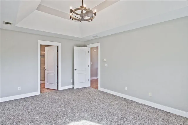 an empty room with a ceiling fan and a window