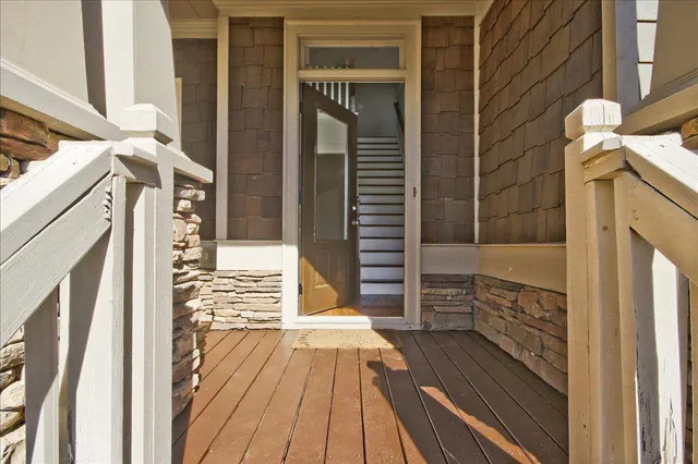a view of balcony with wooden floor and fence