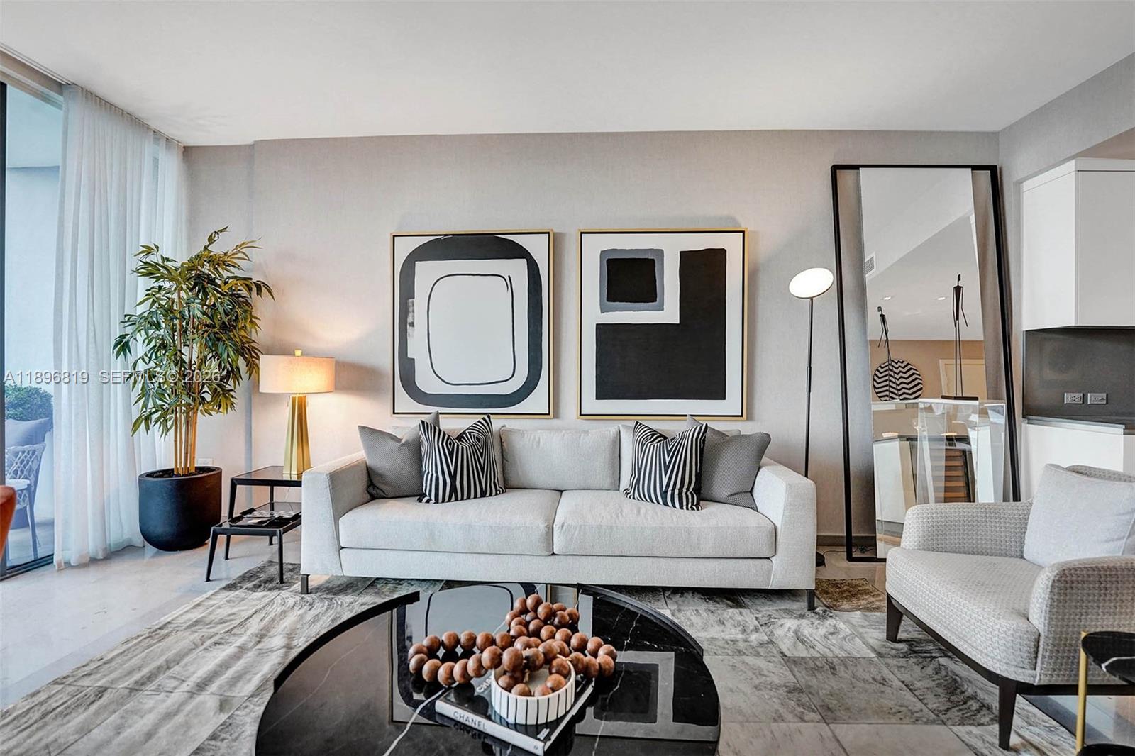 88 Southwest 7th Street, Unit 1408 Miami, FL 33130 - Photo 7 of 16 a living room with furniture and a large mirror