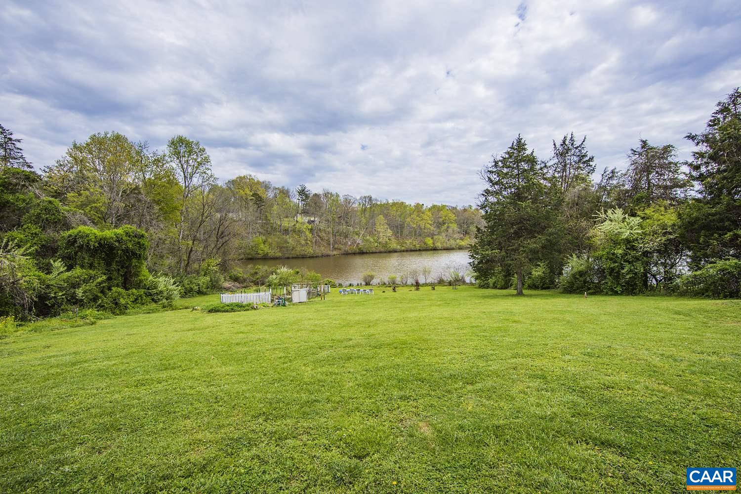 153 Morning Glory Road Ruckersville, VA 22968 - Photo 1 of 33 a view of a big yard with a house in the background