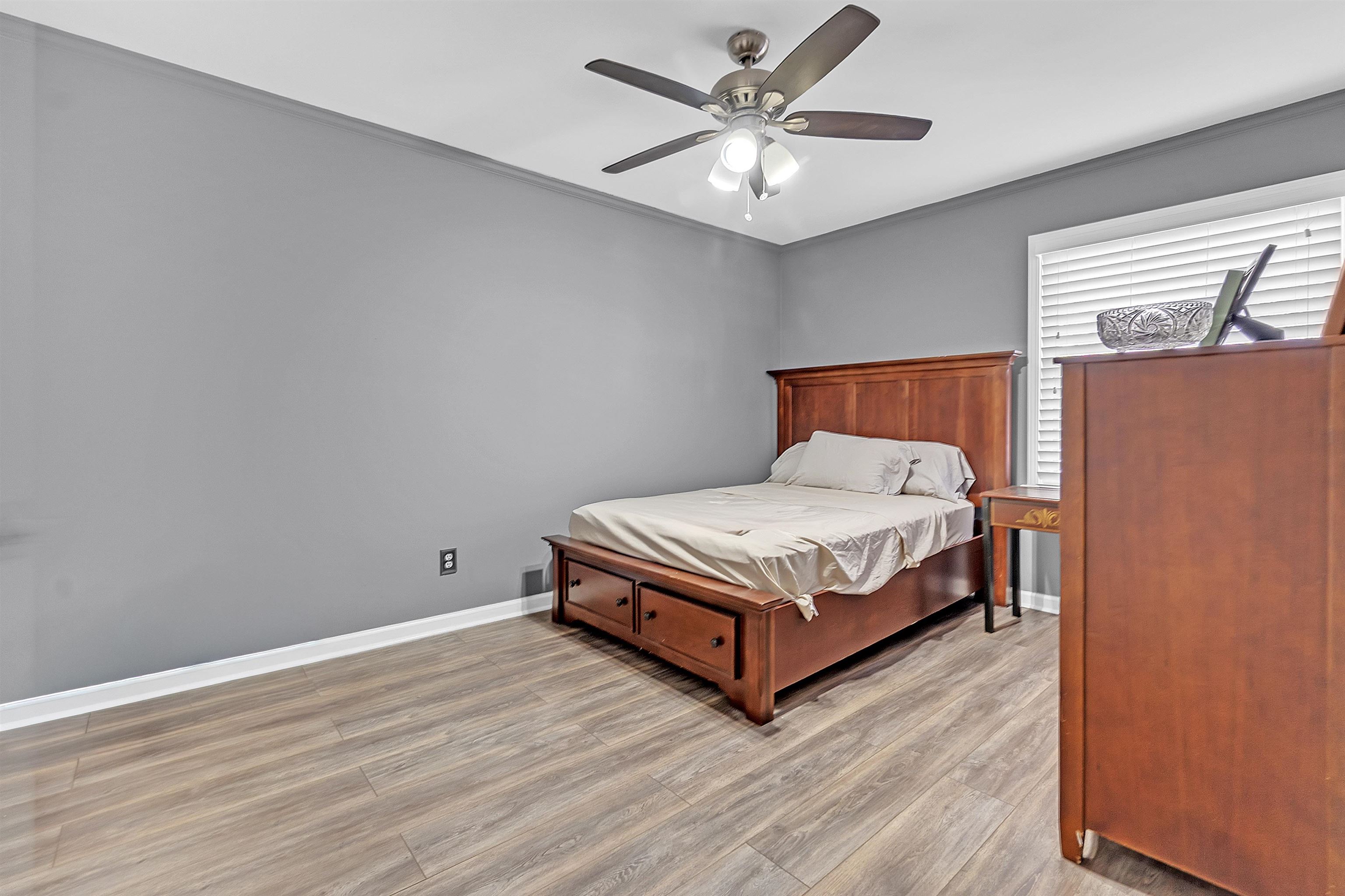 5866 Roxbury Drive, Unit 5866 Memphis, TN 38119 - Photo 14 of 16 Bedroom with light wood-style flooring and a ceiling fan