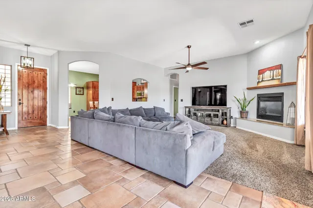 a kitchen with kitchen island granite countertop a sink cabinets and window