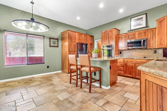 a kitchen with stainless steel appliances granite countertop a sink stove and microwave