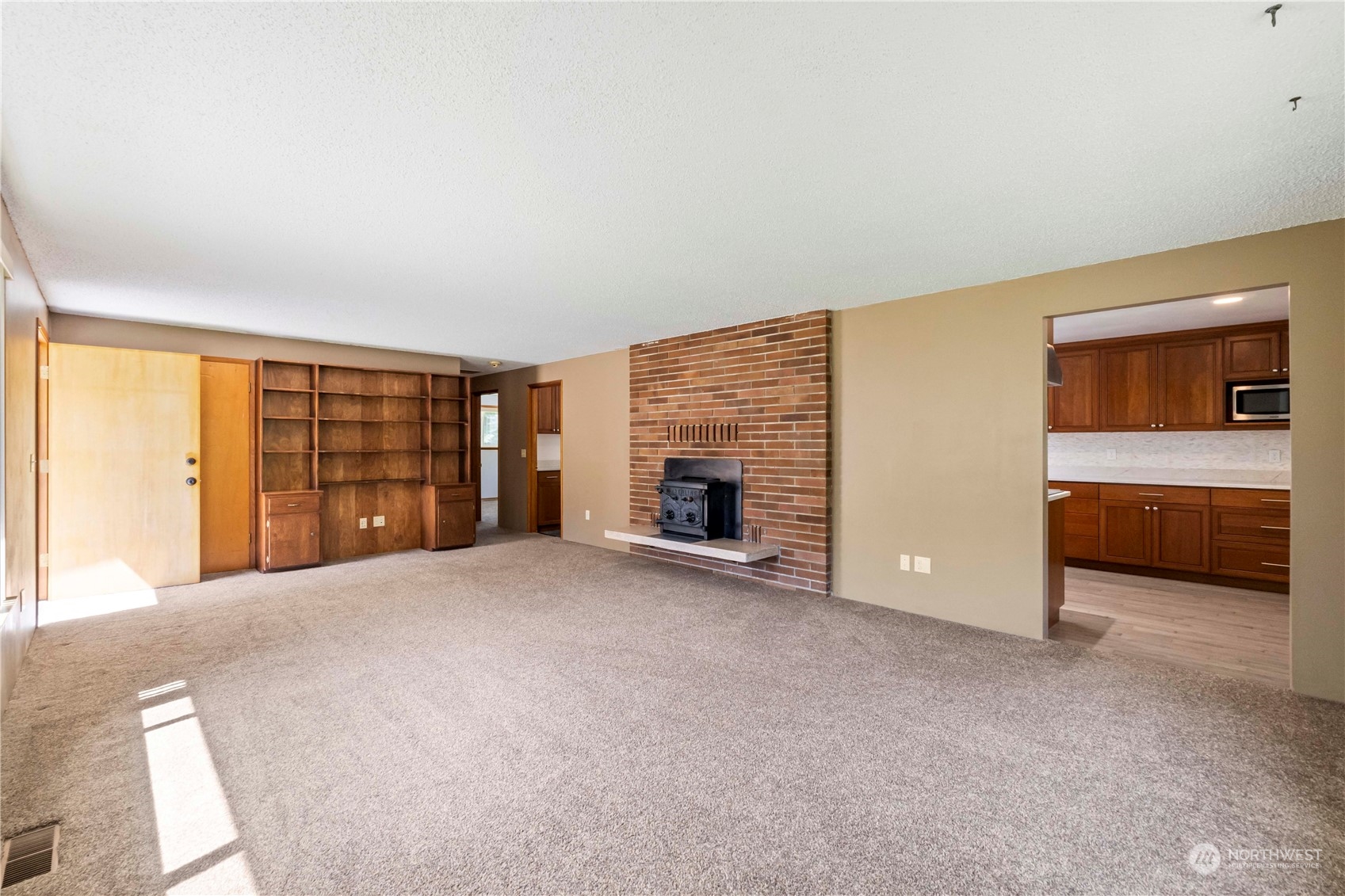 16238 Southeast 144th Street Renton, WA 98059 - Photo 11 of 32 a view of an empty room with a fireplace and a window