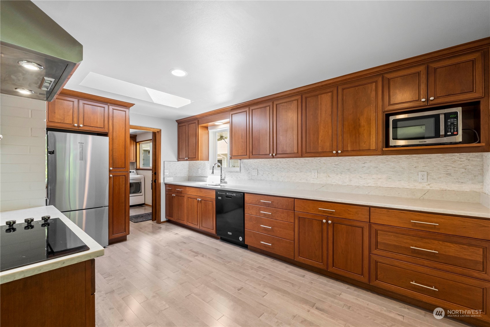 16238 Southeast 144th Street Renton, WA 98059 - Photo 14 of 32 a kitchen with stainless steel appliances granite countertop a refrigerator stove and sink