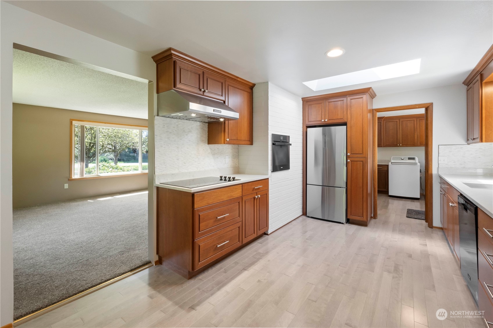 16238 Southeast 144th Street Renton, WA 98059 - Photo 15 of 32 a kitchen with stainless steel appliances a refrigerator and wooden cabinets