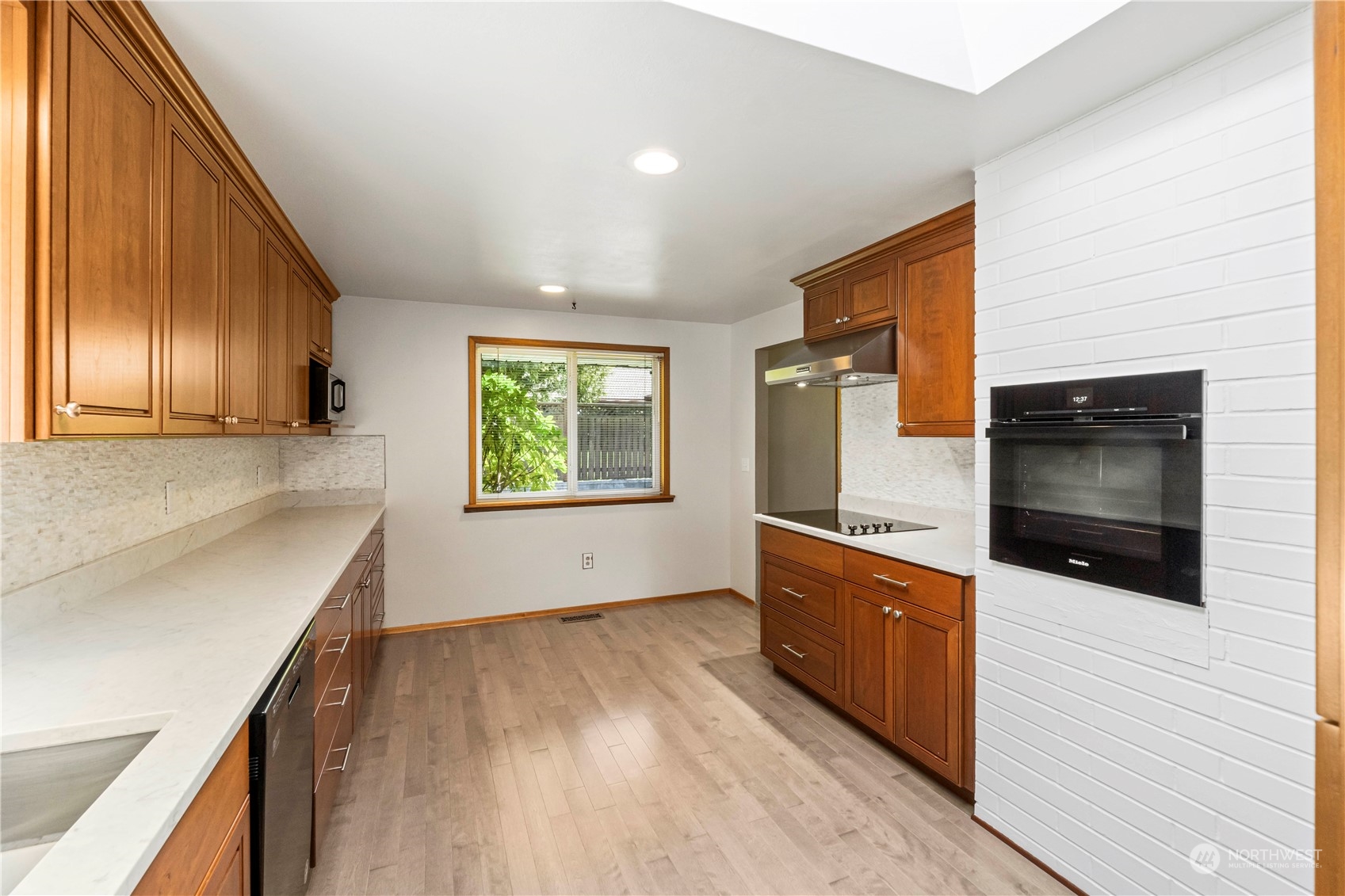 16238 Southeast 144th Street Renton, WA 98059 - Photo 16 of 32 a kitchen with stainless steel appliances a stove microwave and sink