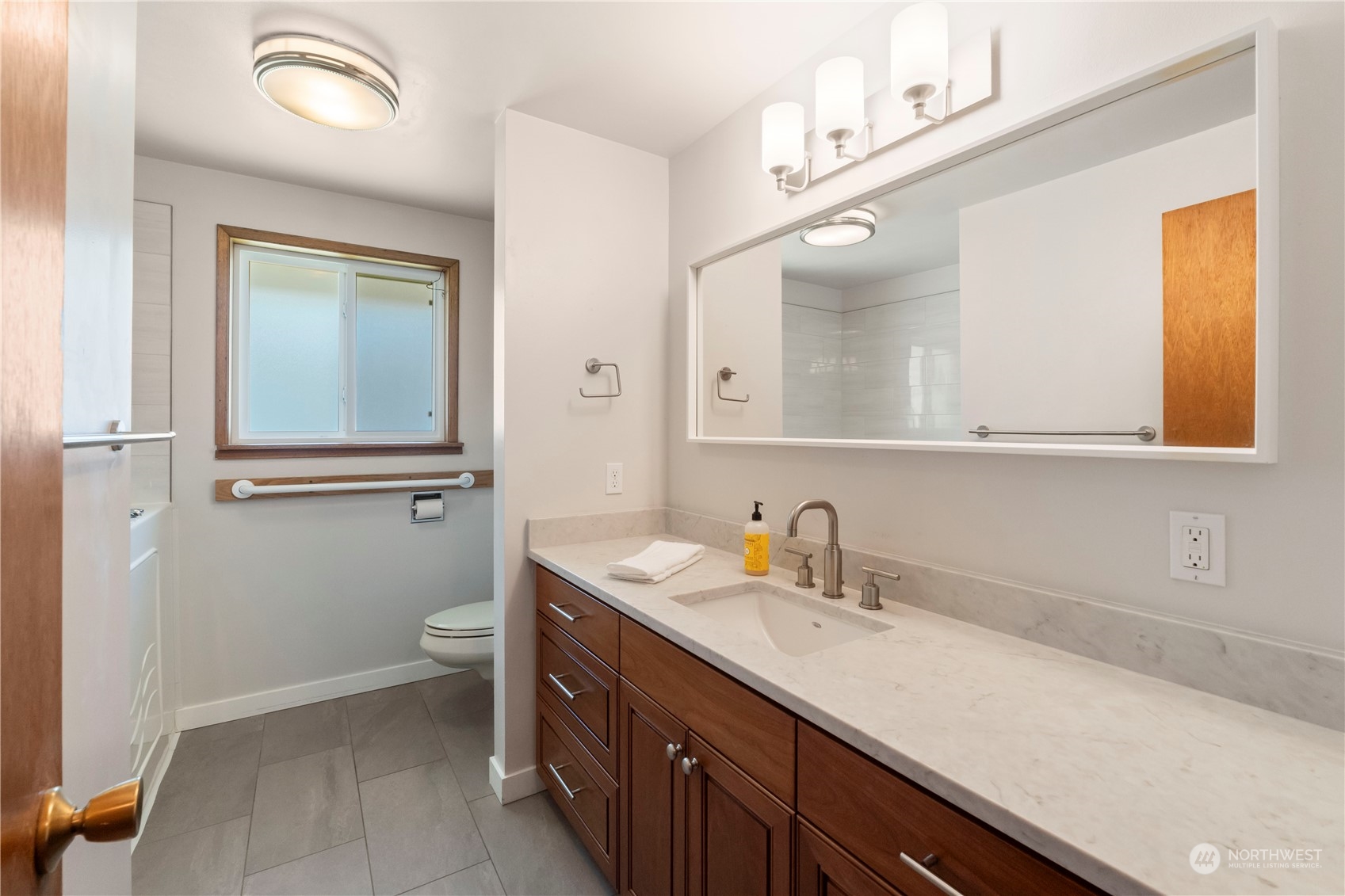16238 Southeast 144th Street Renton, WA 98059 - Photo 20 of 32 a bathroom with a sink a toilet and mirror