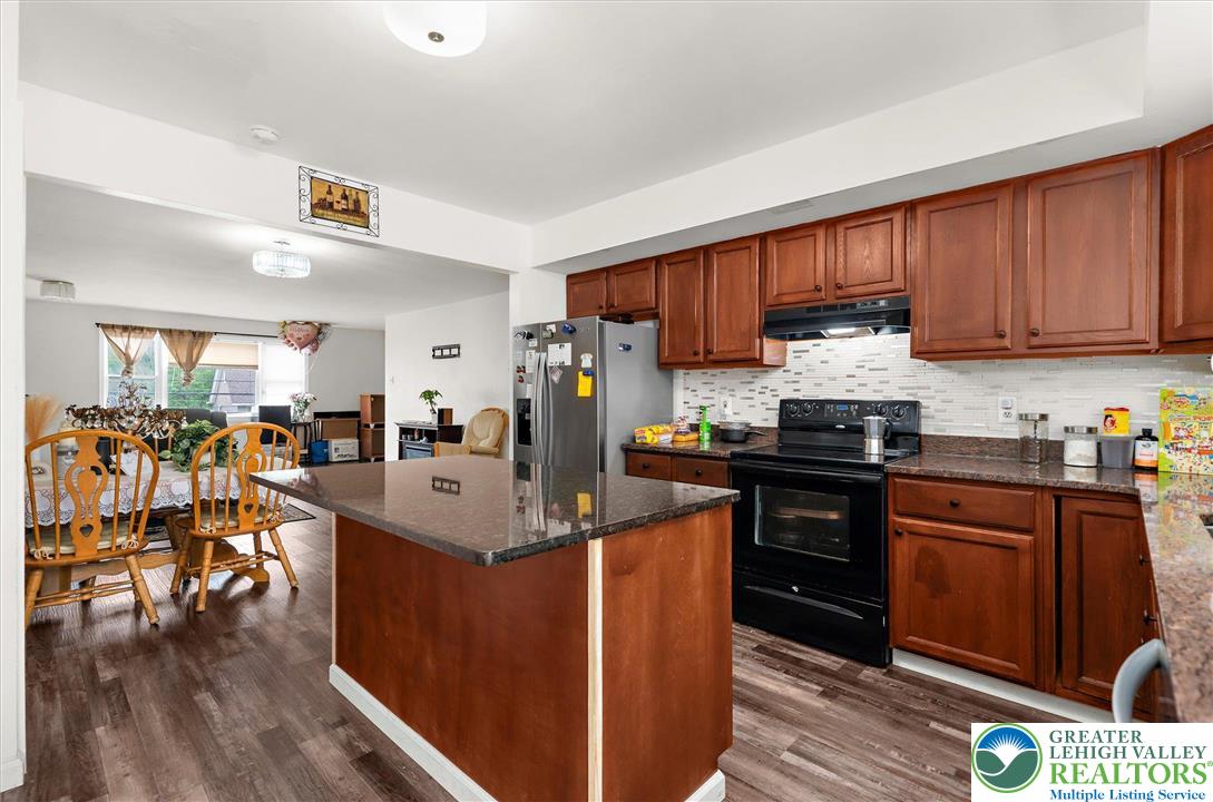 326 Chestnut Street Slatington, PA 18080 - Photo 11 of 28 a kitchen with granite countertop a sink stove and cabinets