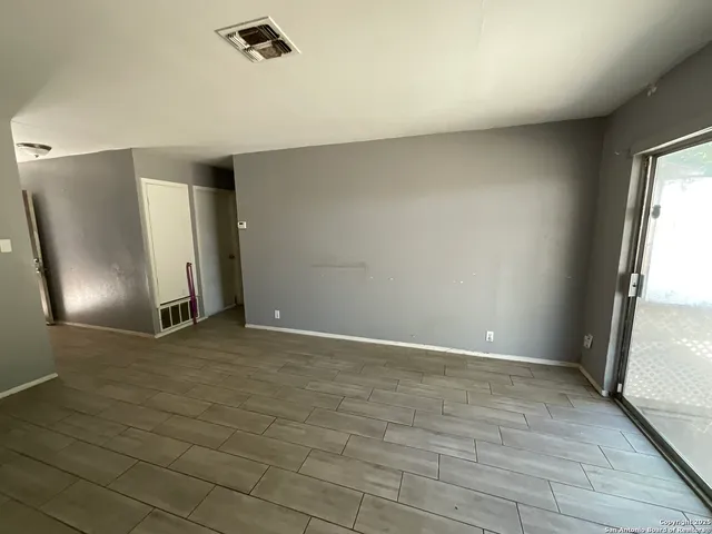 an empty room with a empty space and windows