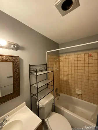 a bathroom with a toilet sink and tub