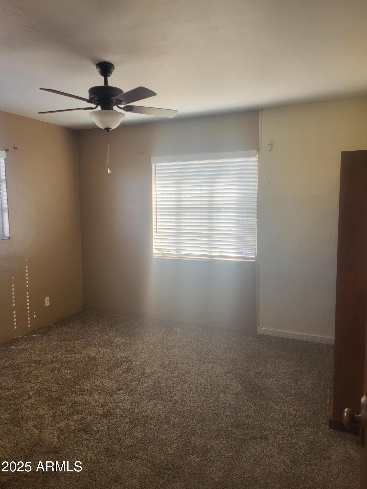 1704 West Colter Street, Unit 1 Phoenix, AZ 85015 - Photo 19 of 25 an empty room with windows and fan