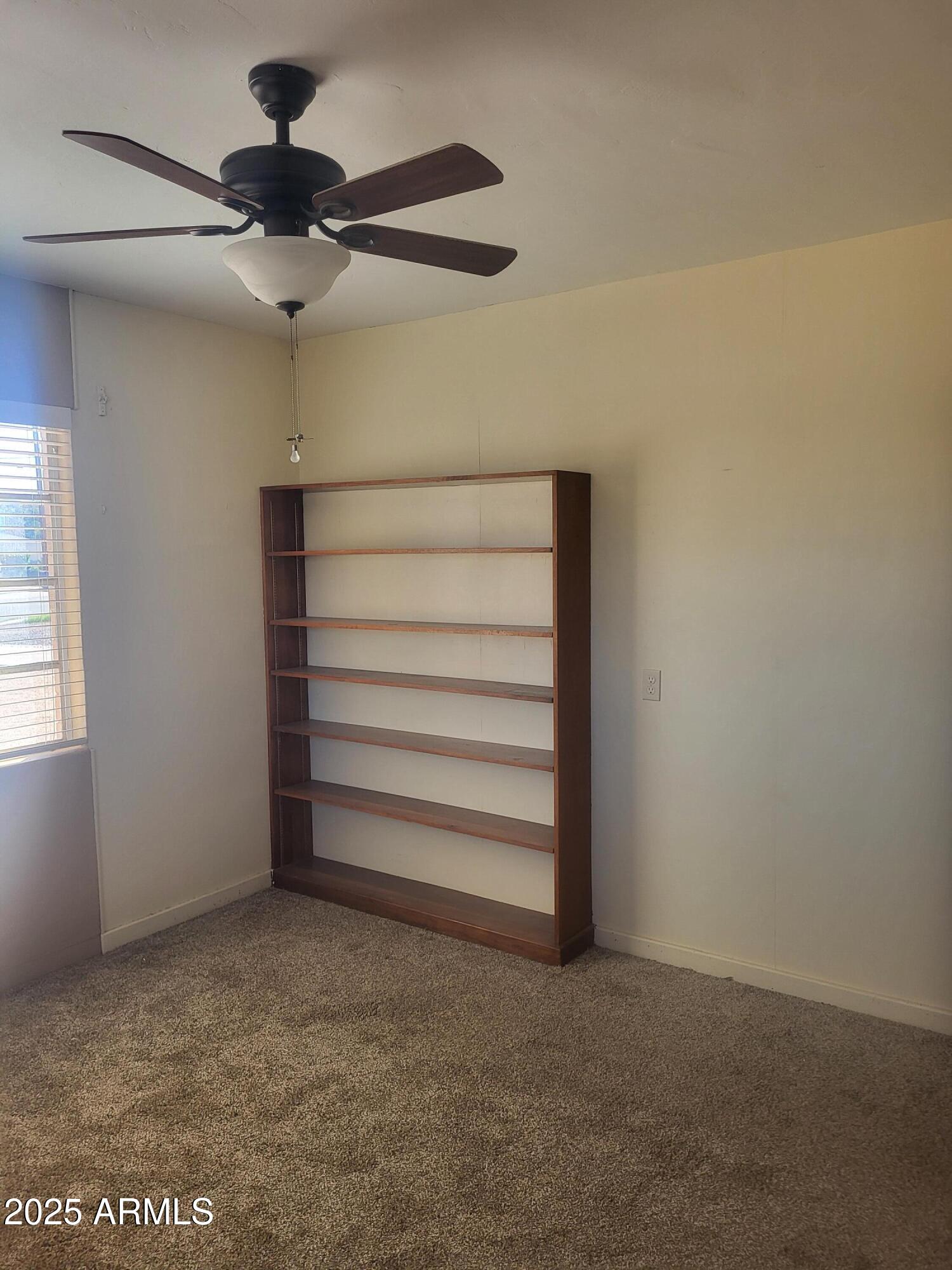 1704 West Colter Street, Unit 1 Phoenix, AZ 85015 - Photo 20 of 25 a view of room that has a ceiling fan and a rug