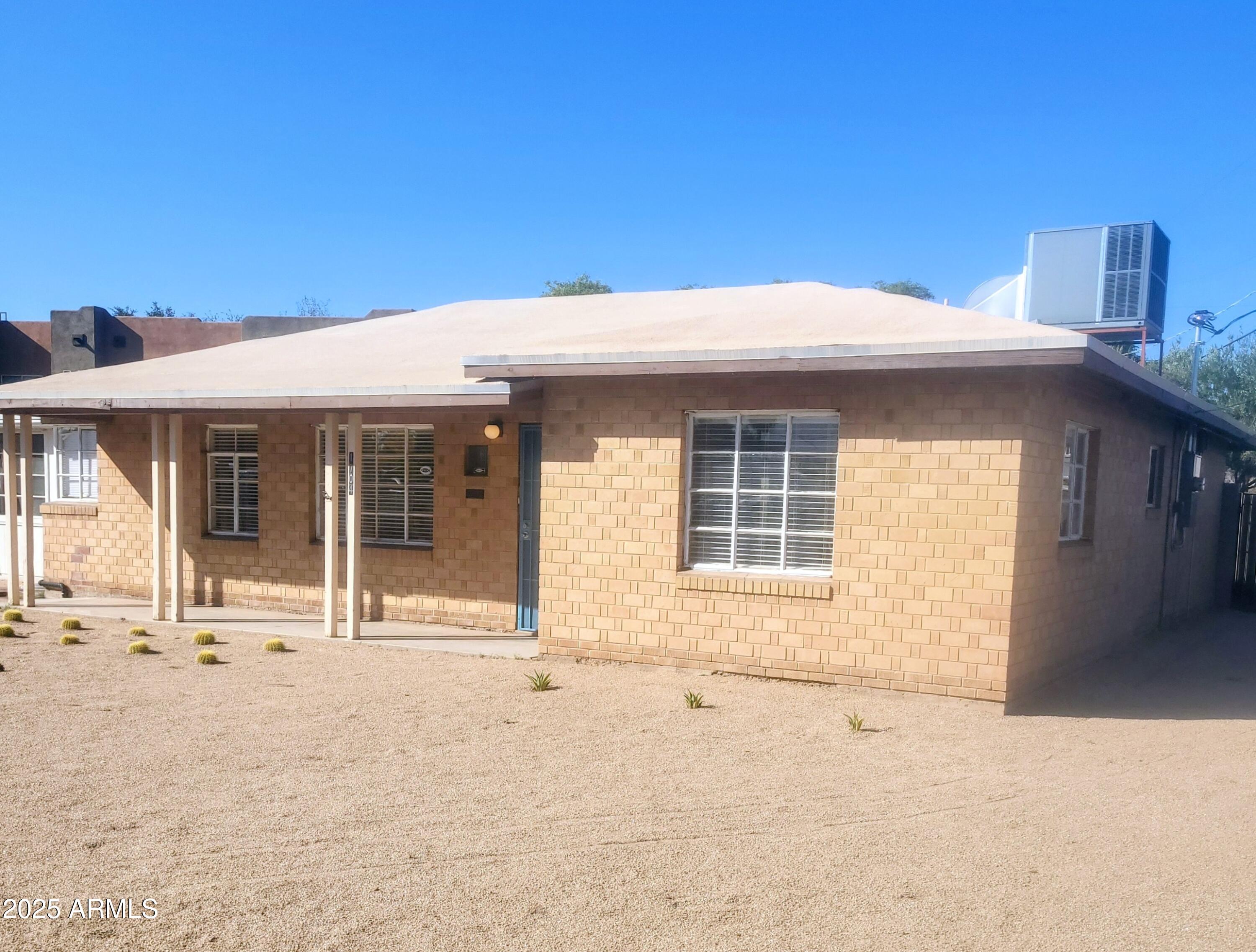 1704 West Colter Street, Unit 1 Phoenix, AZ 85015 - Photo 2 of 25 a front view of a house with a outdoor space
