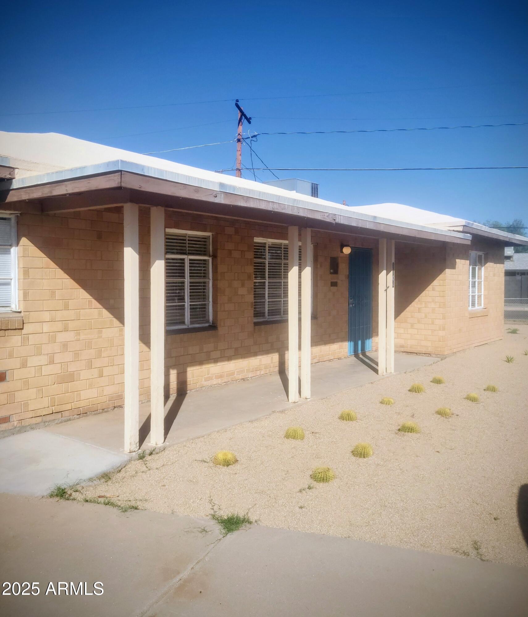 1704 West Colter Street, Unit 1 Phoenix, AZ 85015 - Photo 3 of 25 a view of a house with a yard