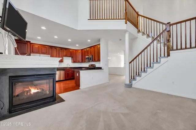 a open kitchen view with fireplace and a sink