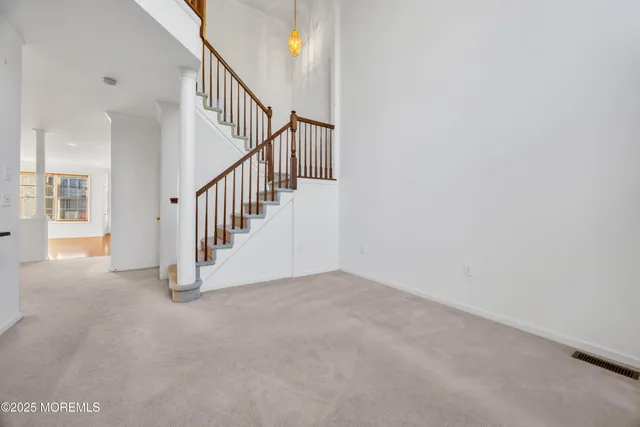 a view of an empty room with stairs