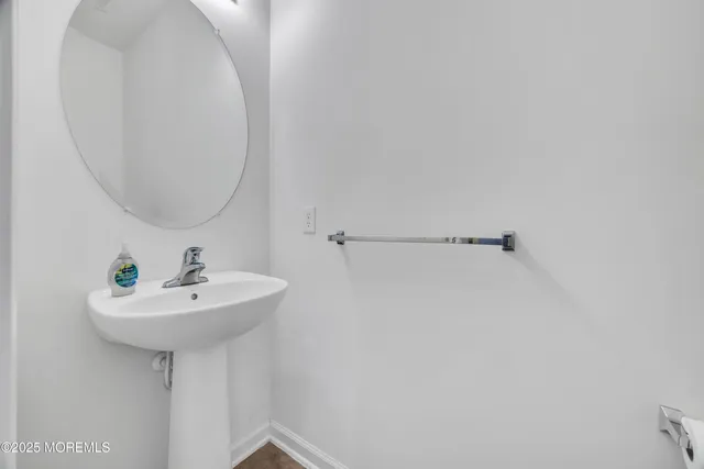 a bathroom with a sink a mirror and a shower