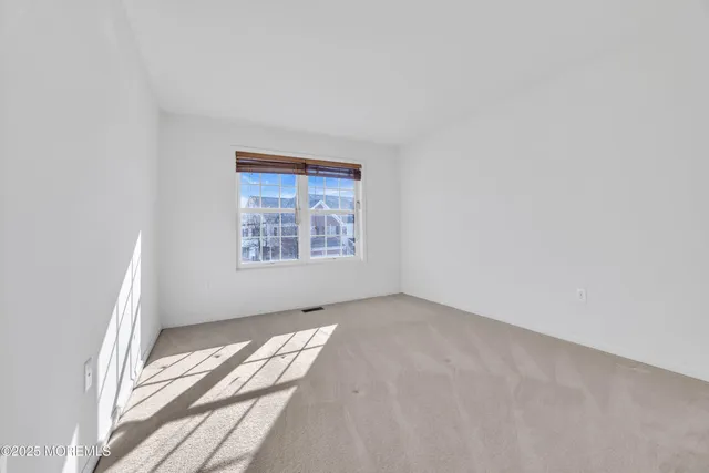 an empty room with a ceiling fan and wooden floor