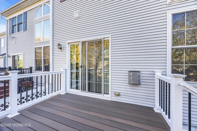 a view of balcony with wooden floor and fence