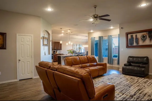 a kitchen with stainless steel appliances kitchen island granite countertop a stove a sink and a refrigerator