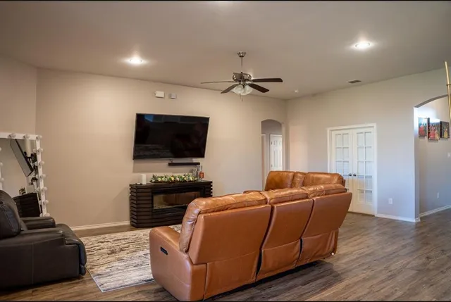 a living room with furniture and a flat screen tv