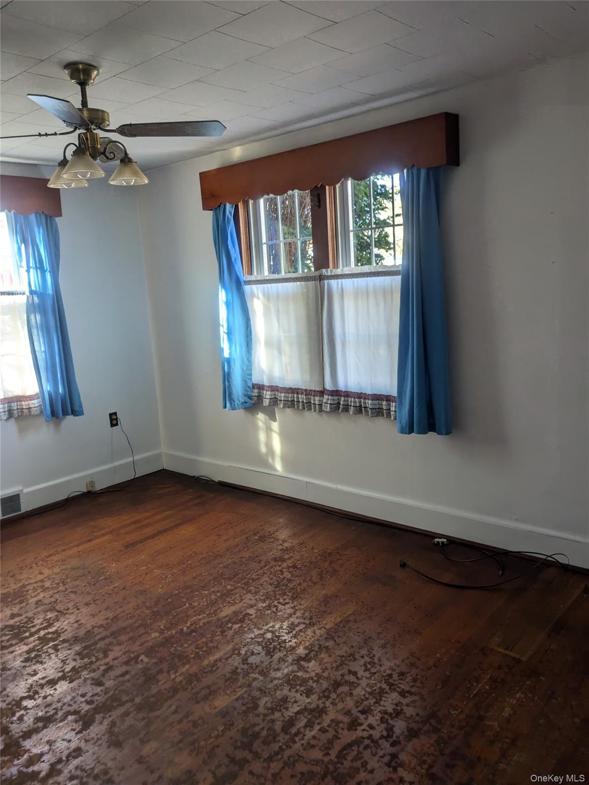 55 Old Little Britain Road Newburgh, NY 12550 - Photo 20 of 44 an empty room with wooden floor fan and windows