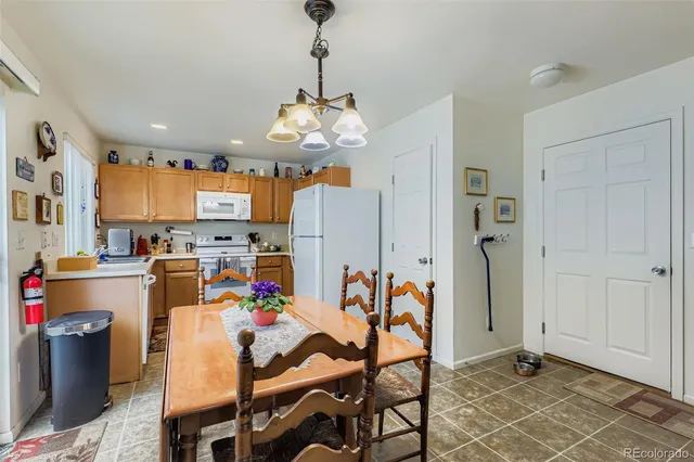 a view of a dining room with furniture and a chandelier