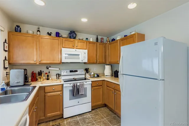 a kitchen with a white cabinets and white appliances