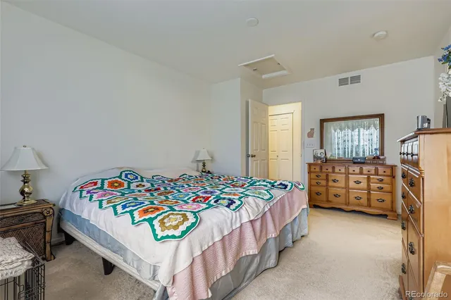 a bedroom with a bed and a dresser in it