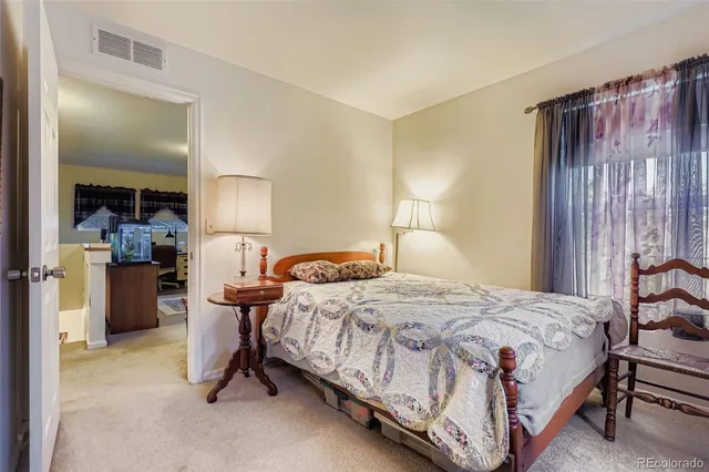 a bedroom with a bed and a table in it