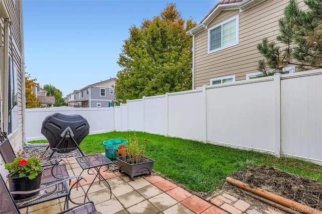 a view of a backyard with sitting area