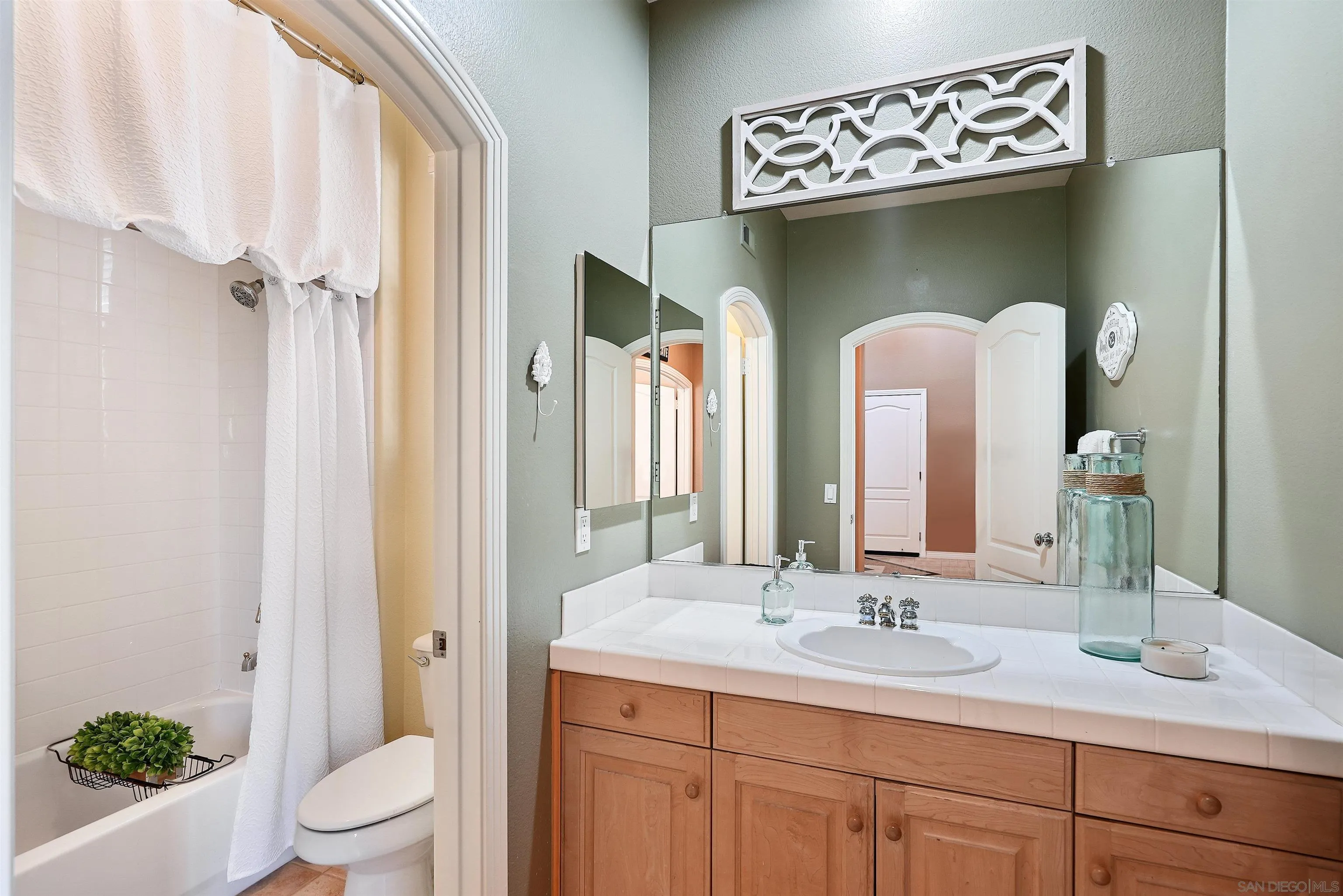 7539 Reeve Road Carlsbad, CA 92011 - Photo 16 of 30 a bathroom with a granite countertop sink a toilet and a mirror