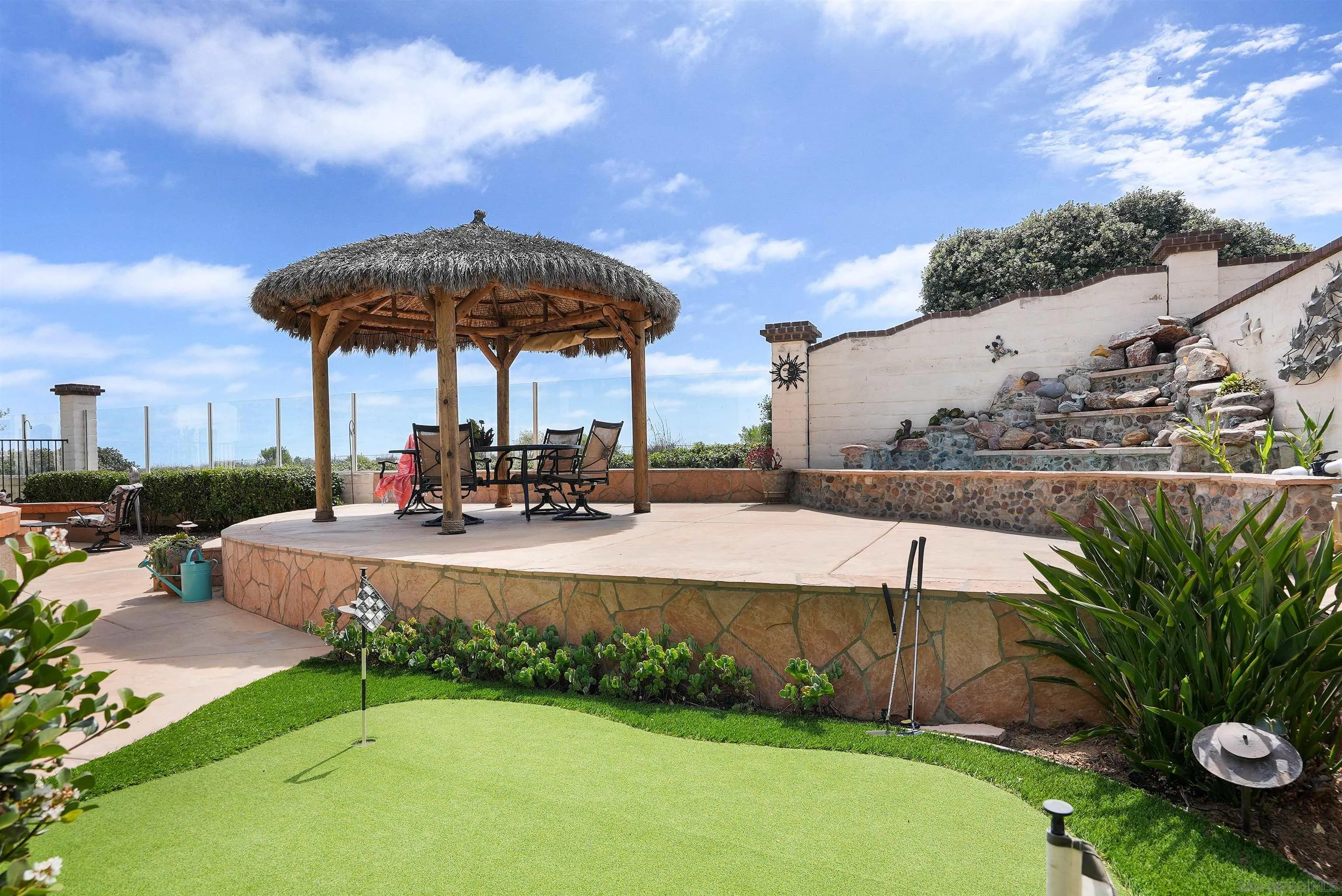 7539 Reeve Road Carlsbad, CA 92011 - Photo 22 of 30 a view of a swimming pool with a table and chairs under an umbrella