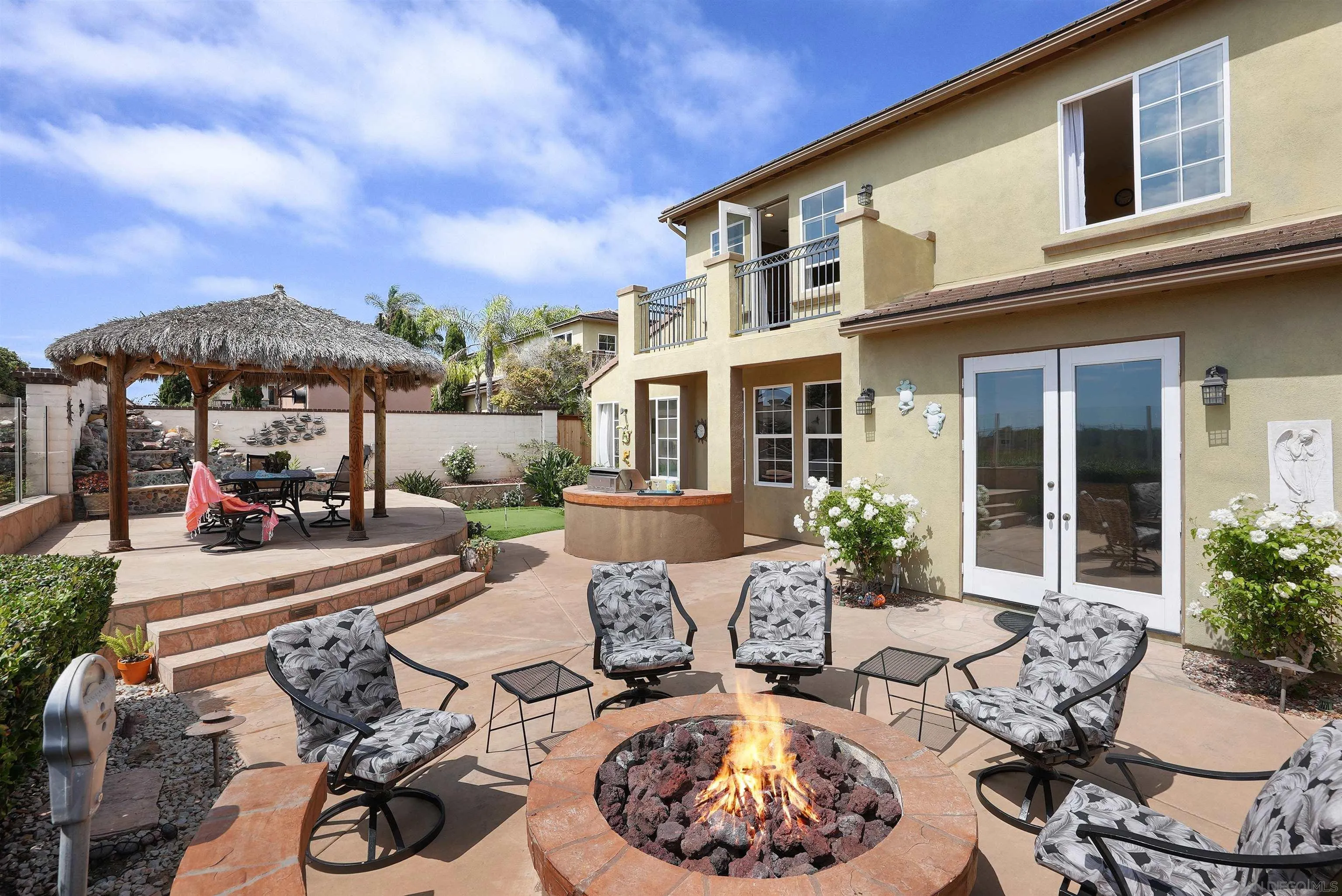 7539 Reeve Road Carlsbad, CA 92011 - Photo 24 of 30 a view of a patio with couches table and chairs and potted plants