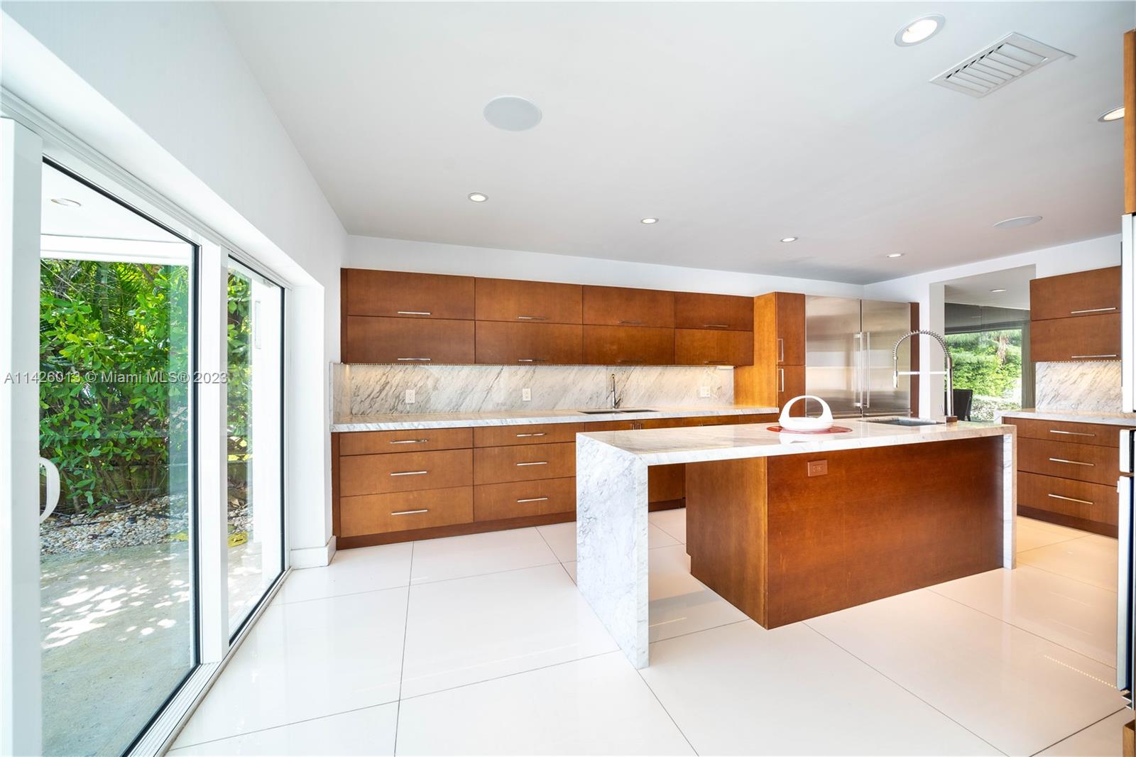 Palm Island Miami Beach, FL 33139 - Photo 18 of 50 a large kitchen with stainless steel appliances wooden cabinets and a large window