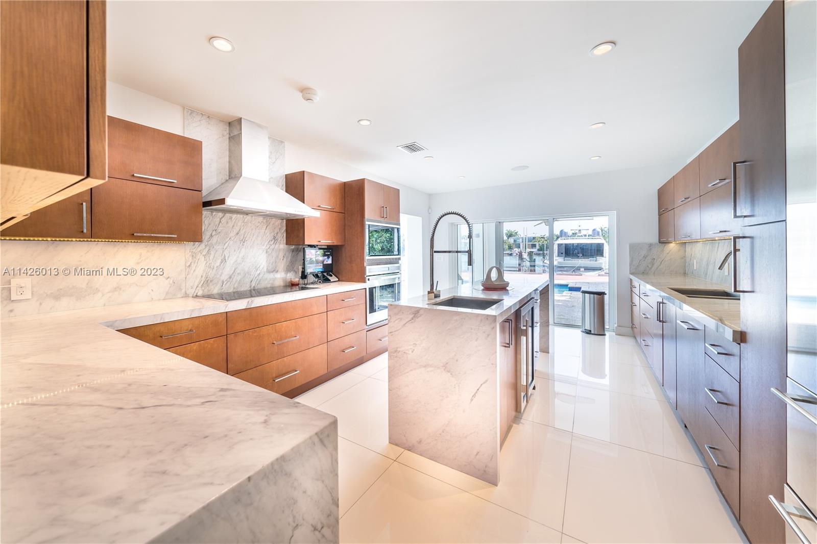 Palm Island Miami Beach, FL 33139 - Photo 19 of 50 a living room with stainless steel appliances kitchen island granite countertop a sink and cabinets