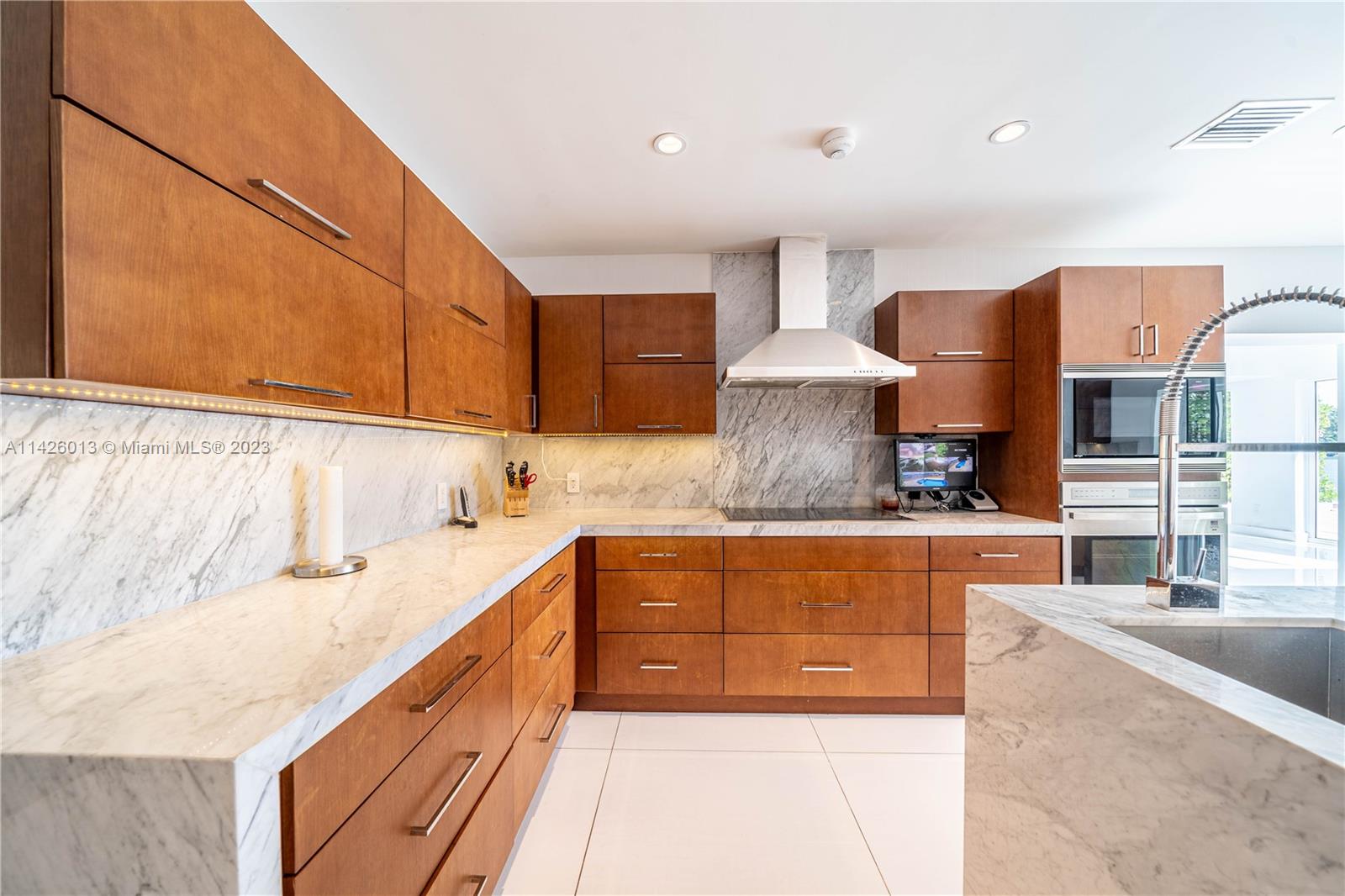 Palm Island Miami Beach, FL 33139 - Photo 20 of 50 a kitchen with stainless steel appliances granite countertop a sink and cabinets