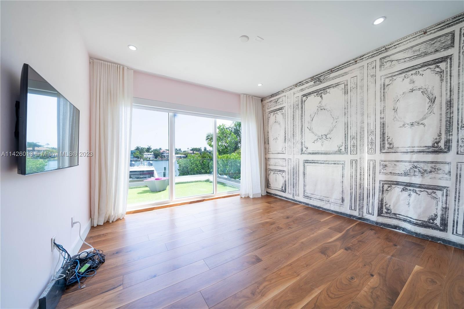 Palm Island Miami Beach, FL 33139 - Photo 36 of 50 a view of an empty room with wooden floor and a window
