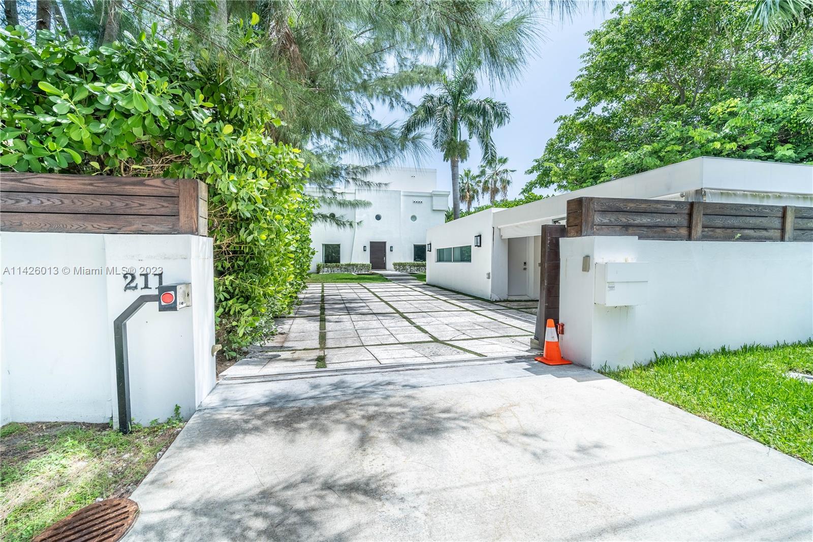 Palm Island Miami Beach, FL 33139 - Photo 4 of 50 a view of a white house with a small yard and a large tree