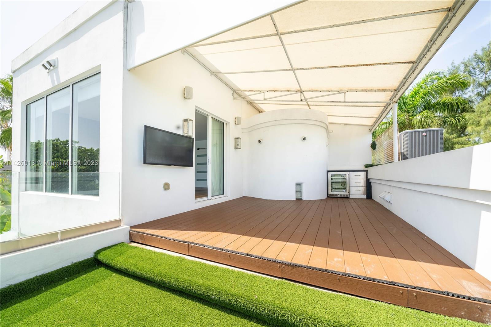 Palm Island Miami Beach, FL 33139 - Photo 43 of 50 a spacious bedroom with a bed and a flat screen tv