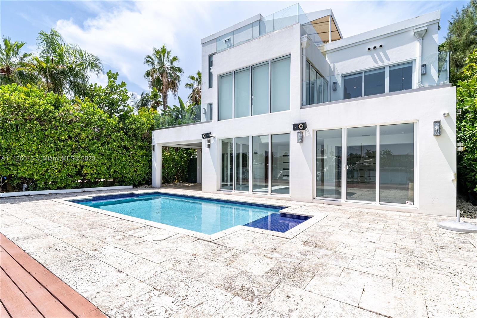 Palm Island Miami Beach, FL 33139 - Photo 47 of 50 a view of a white house with a swimming pool