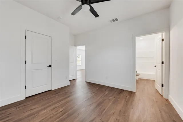a view of a room with wooden floor and white walls