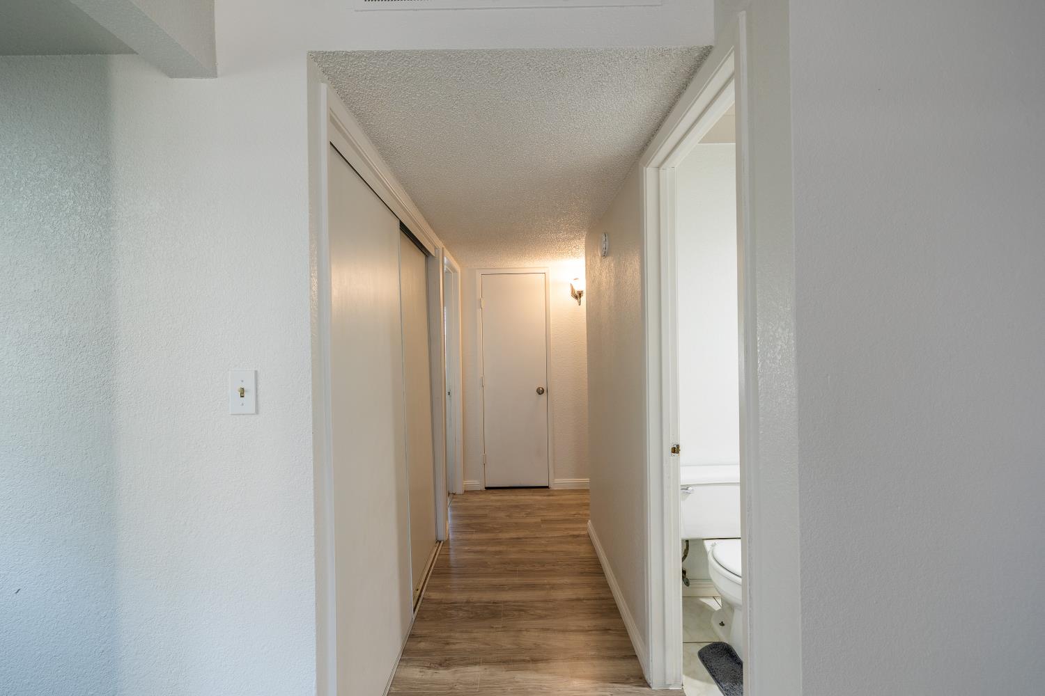 3700 Tully Road, Unit 5 Modesto, CA 95356 - Photo 13 of 38 a view of a hallway with wooden floor